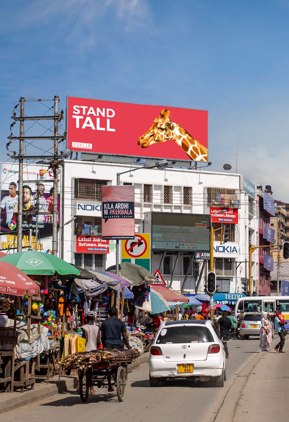 A static billboard above a busy market street in Dar es Salaam