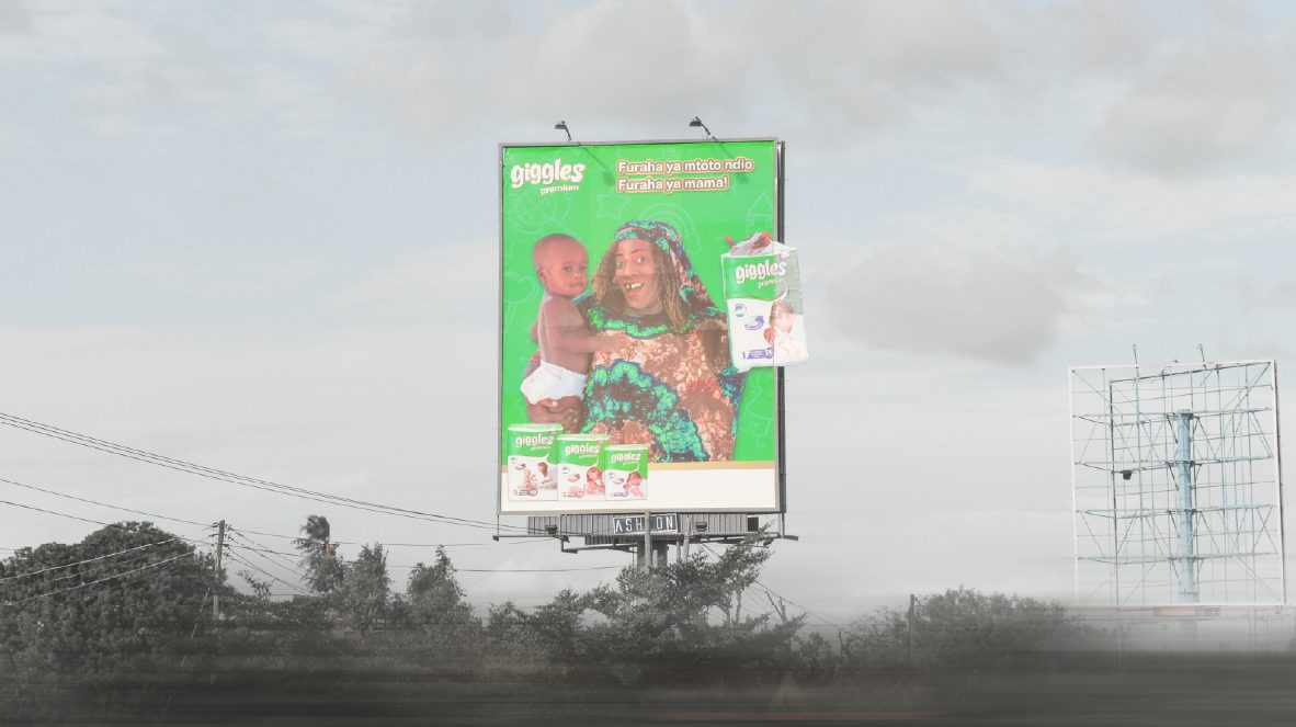 A billboard campaign on a misty morning outside Dar es Salaam