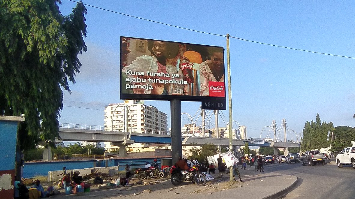 A Coca-Cola billboard beside a flyover
